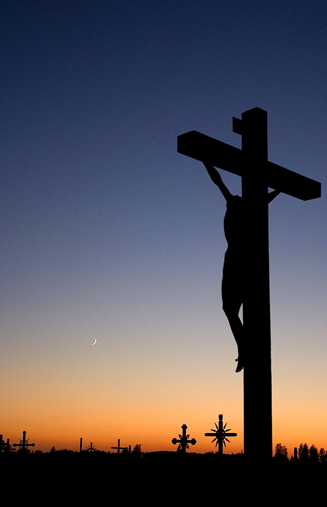 Silhouette of the monument to visit of Pope John Paul II on 07.09.1993 against the evening twilight on the Hill of Crosses, Siauliai, Lithuania, Europe