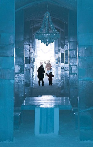 Long hall with a table and a chandelier made of ice, ice hotel of Jukkasjaervi, Lappland, Northern Sweden