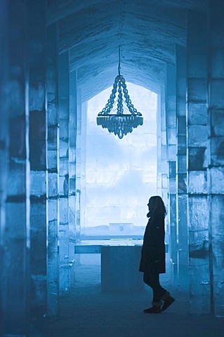 Long hall with a table and a chandelier made of ice, ice hotel of Jukkasjaervi, Lappland, Northern Sweden