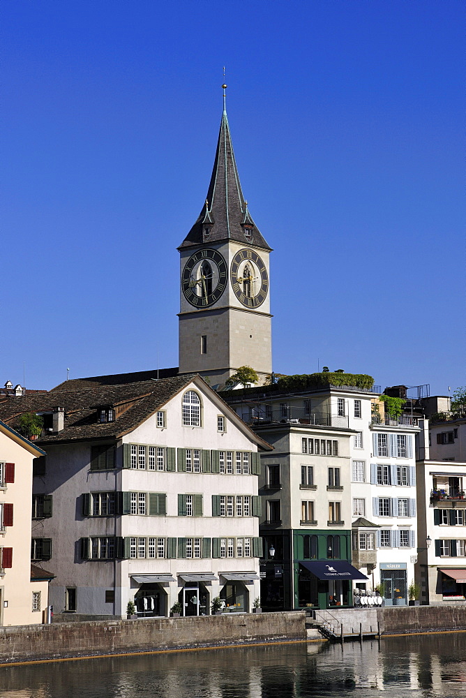 Tower of St. Peter's Church overlooking the rooftops of the historic town centre of Zurich with the Limmat River in the foreground, Zurich, Switzerland, Europe