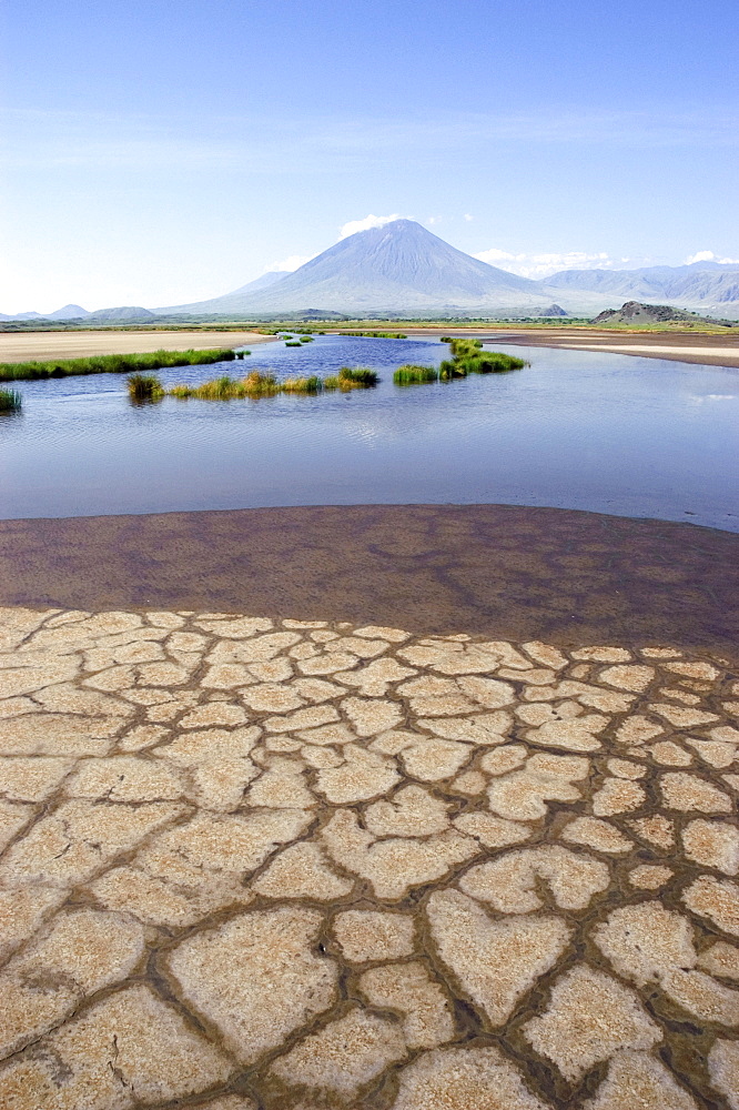 Shore of Lake Natron, Oldoinyo Lengai volcano at back, Tanzania, Africa