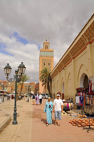 Moroccan couple in front of the tower of the Kasbah Mosque, Marrakesh, Morocco, Africa