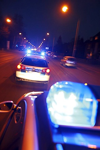 German police cars, blue design, in action with flashing sirens