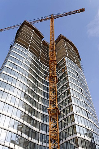 Skyoffice, high rise office building with construction crane, half finished glass facade, building site, Kennedydamm, Duesseldorf, North Rhine-Westphalia, Germany, Europe