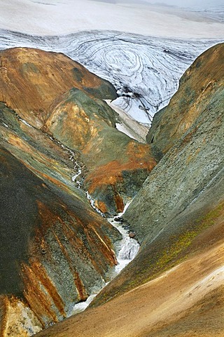 Hills coloured by minerals and colourful Rhyolith Mountains below the Kerlingarfjoell Glacier, criss-crossed by streams, Iceland, Europe