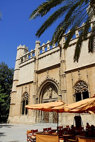 Terrace with sun shades in front of the medieval entrance portal of Sa Llotja, former maritime trade stock exchange, used today for exhibitions of art and culture, facade in the Catalonian gothic style, historic city centre, Ciutat Antiga, Palma de Mallor