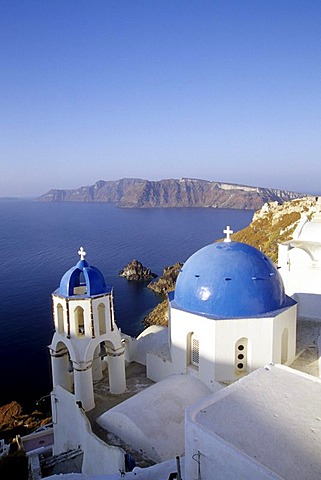 Village of Oia with a church in white and blue, view of the caldera, Island of Thirasia, Therasia in the back, Island of Santorini, Thera or Thira, Cyclades, the Aegean, Mediterranean Sea, Greece, Europe