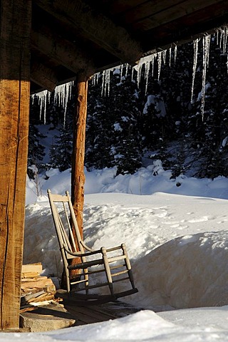 Old lodge with rocking chair, icicles, Dunton Hot Springs Lodge, Colorado, USA