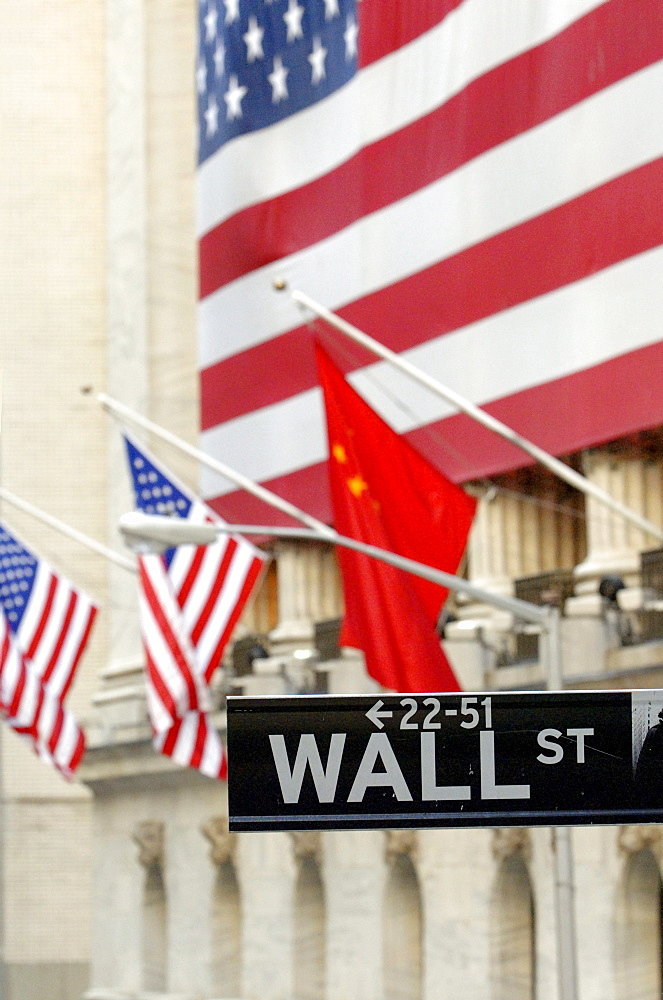 Wall Street, street sign in front of American flags, New York Stock Exchange, Financial District, Manhattan, New York City, NYC, New York, United States of America, USA