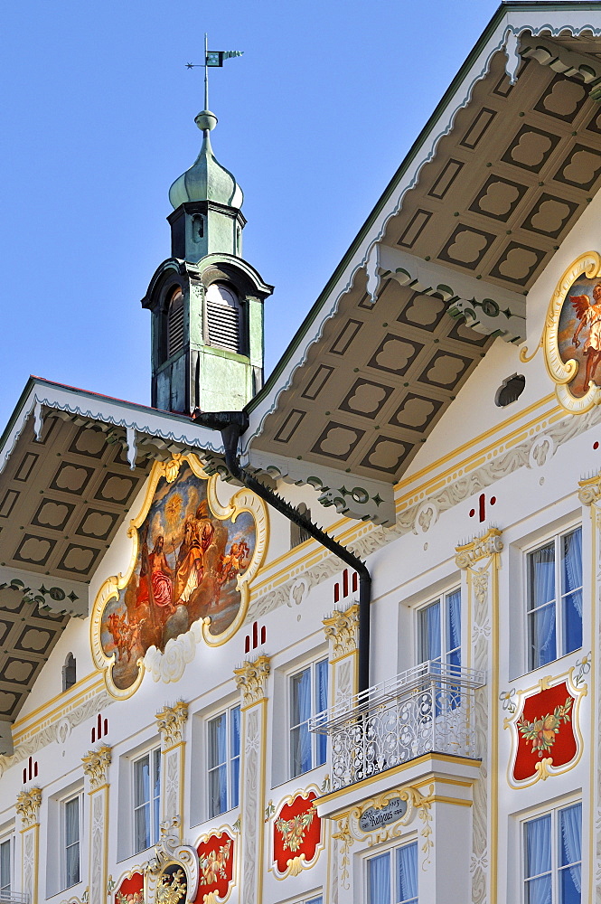 Building facade brightly painted (lueftlmalerei) beneath tower and weather vane, town hall, Bad Toelz, Bavaria, Germany