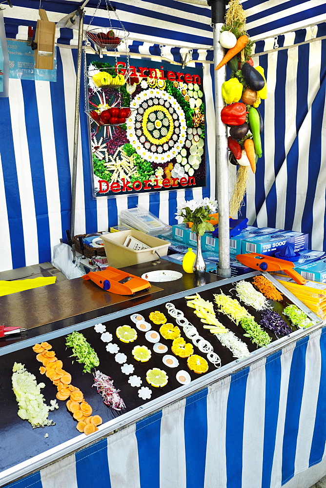 Booth selling slices of various fruits and vegetables, Auer Dult Fair, Munich, Bavaria, Germany