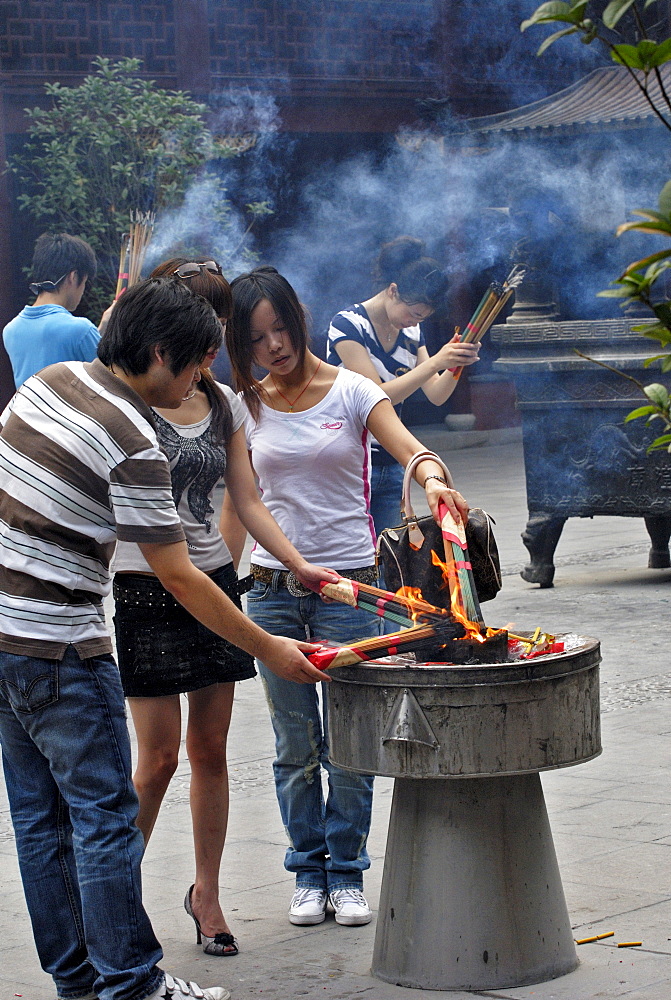 People lighting joss sticks, Yuyuan Garden, Shanghai, China, Asia