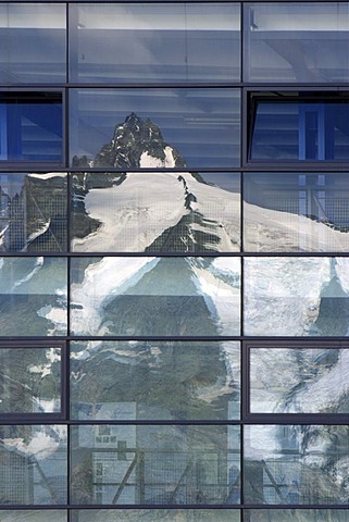 Reflection of mountain Grossglockner on glass front of parking house on Franz Josefs Hohe Carinthia Austria