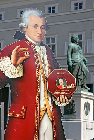 Advertising for the Salzburger Mozartkugel with a portrat of Mozart made of cardboard in the background the memorial of Mozart on the Mozart square town of Salzburg Austria