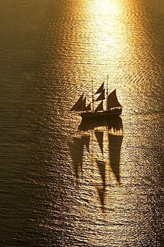 Sailing ship on the sea at sunset, Oia, Santorini, Greece