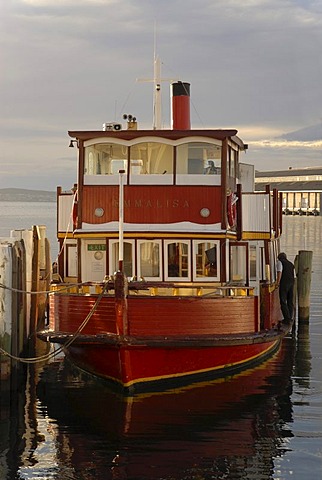 Boat illuminated by warm morning light in the harbor of Hobart, Tasmania, Australia