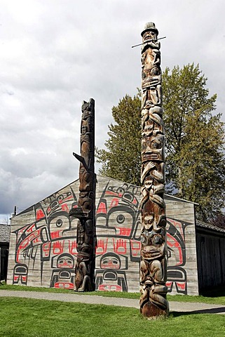 Totem pole in front of long houses at Ksan Historical Village, British Columbia, Canada