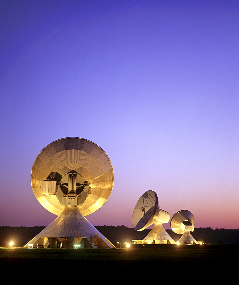 Dusk, lit antennas of the ground communication station Raisting, Upper Bavaria, Germany