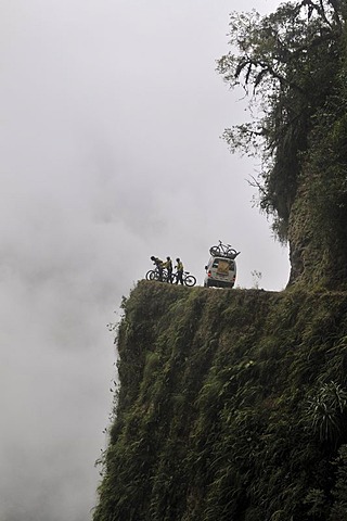 Mountainbikers at the edge of a dangerous cliff, Deathroad, Yungas, La Paz, Bolivia, South America