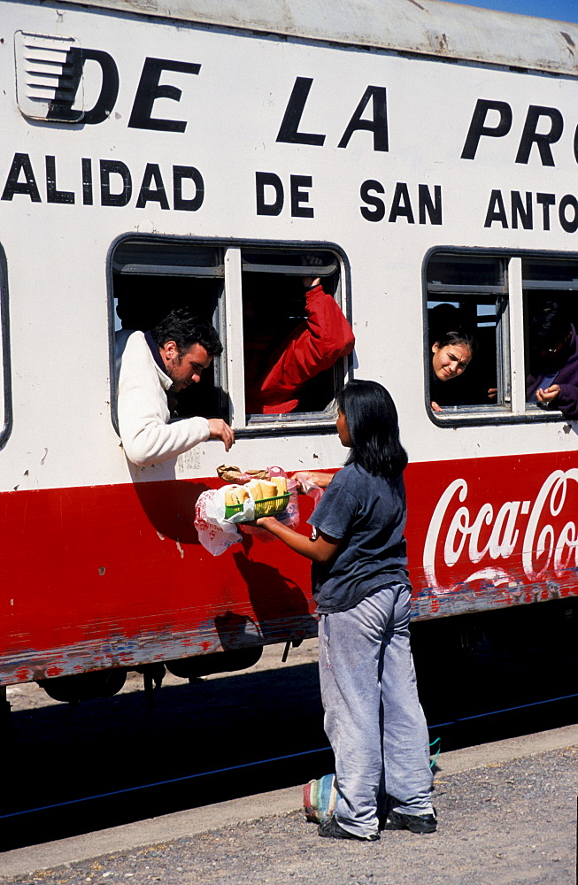 Saleswoman in front of carriage, Tren a las Nubes, Cloud Train car, Salta Province, Argentina