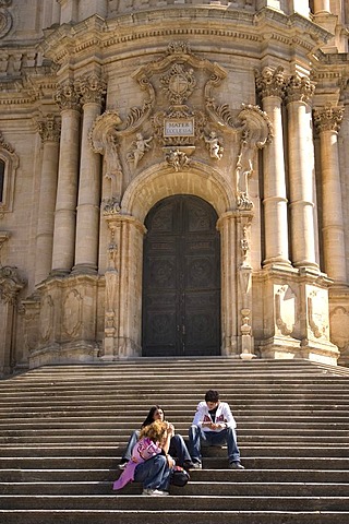 On the stairs in front of the Cathedral of San Giorgio main portal Modica Italy