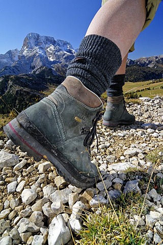 Legs of a hiker with climbing boots