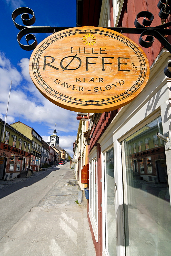 Wooden sign hanging outside a shop in Roeros, iron mining town, UNESCO World Heritage Site, Sor-Trondelag, Norway