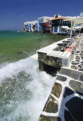 Wave crashing on the promenade along the port of Little Venice, Mykonos Island, Cyclades, Greece, Europe