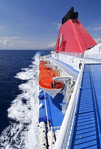 Lifeboats suspended on the side of a car ferry at sea, Mediterranean, Europe