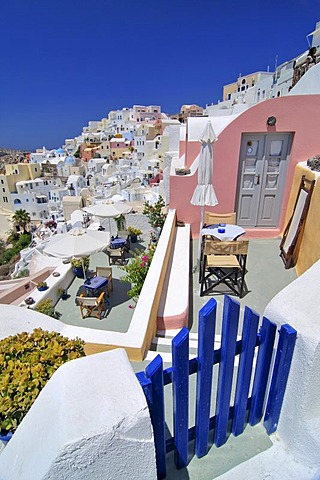 Blue wooden gate in front of interlocked houses, Oia, Ia, Santorini, Cyclades, Greece, Europe