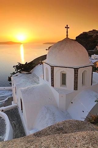White domed church with a cross at sunset, Thira, Fira, Santorini, Cyclades, Greece, Europe