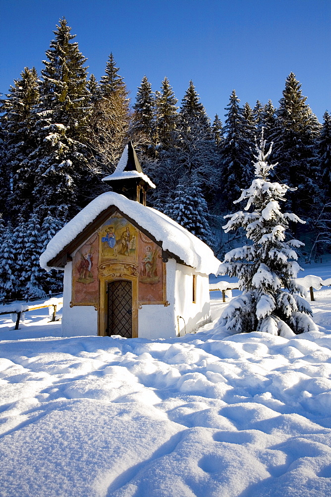 "Lueftlmalerei" (religious facade paintings) on a chapel with Christmas tree, Elmau near Klais, Mittenwald, Upper Bavaria, Germany, Europe