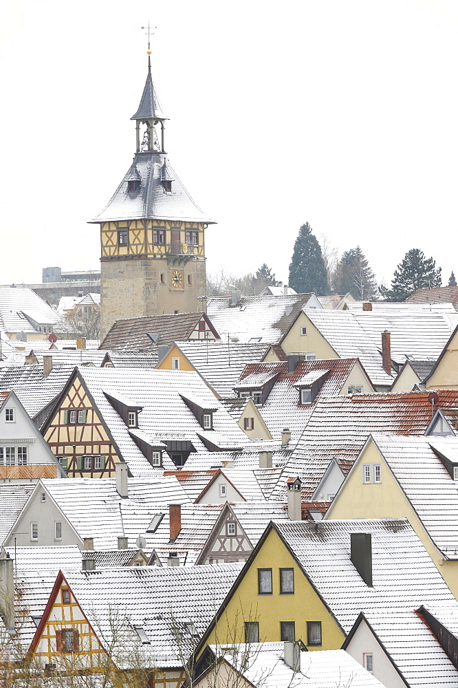 View over snow dusted rooftops, timber framed houses and Upper Gate Tower of the historic centre of Marbach am Neckar, Baden-Wuerttemberg, Germany