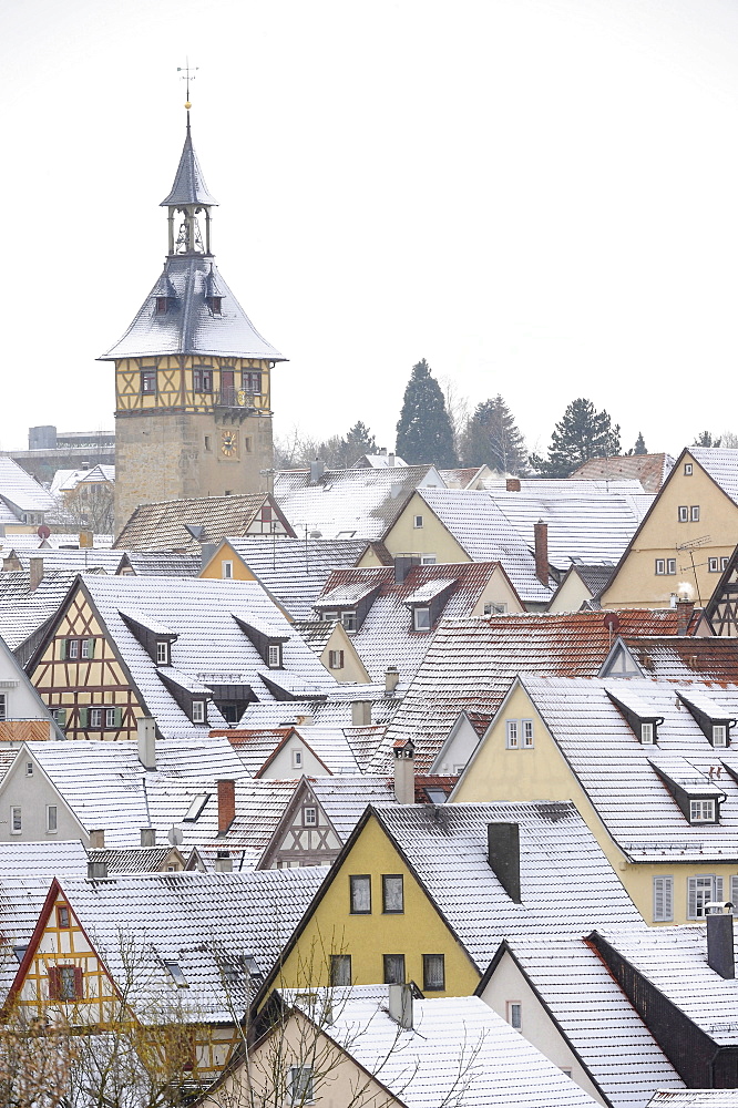 View over snow dusted rooftops, timber framed houses and Upper Gate Tower of the historic centre of Marbach am Neckar, Baden-Wuerttemberg, Germany