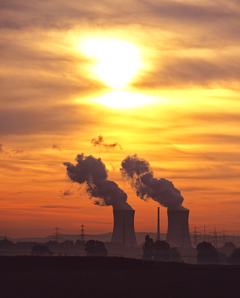 Nuclear power plant cooling towers in a colourful evening sky