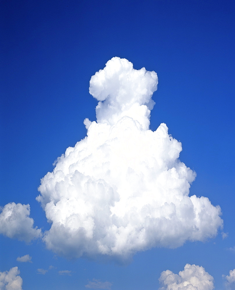 Pyramid-shaped cumulus cloud in a blue sky