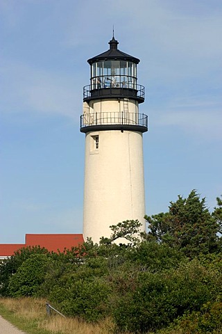 Highland Light (Cape Cod Light). The station was established in 1797, the present buildings date from 1857. At that time, the lighthouse was still 150m away from the 40m cliffs, but continuing erosion imperiled the location. At the end of the 20th century