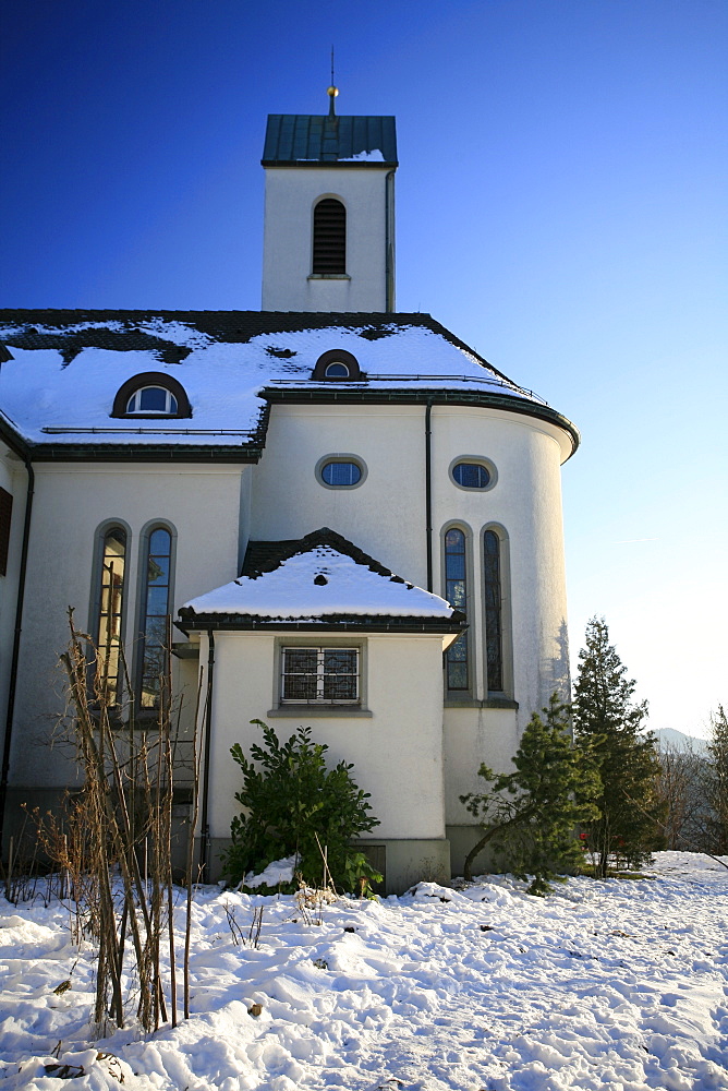 The Church of St. Iddaburg is sitting on the hill where the old Toggenburg castle stood high above Kirchberg village, St. Gallen, Switzerland