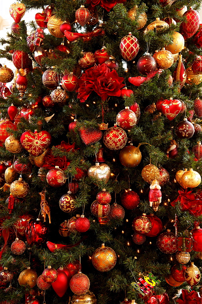 Detail shot, colourful Christmas ornaments hanging in Christmas tree