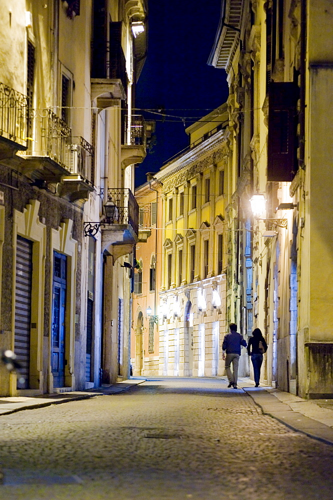 Couple walking through the historic centre of Verona, Italy, Europe