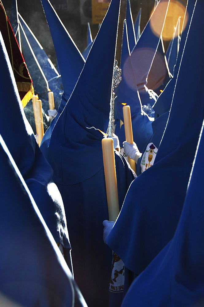 Penitents dressed in blue penitential robes (nazareno), Semana Santa, Holy Week Procession, Seville, Andalusia, Spain