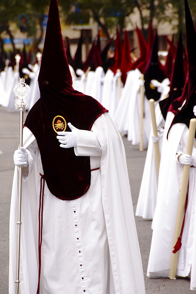 Penitents dressed in penitential robes, nazareno, Holy week procession, Semana Santa, Seville, Andalusia, Spain