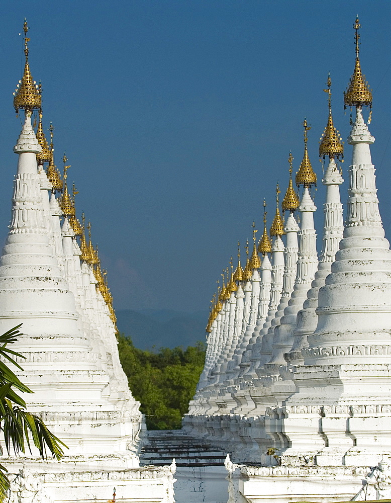 Lots of golden-tipped white stupas in two rows, Mandalay, Myanmar (Burma), Southeast Asia