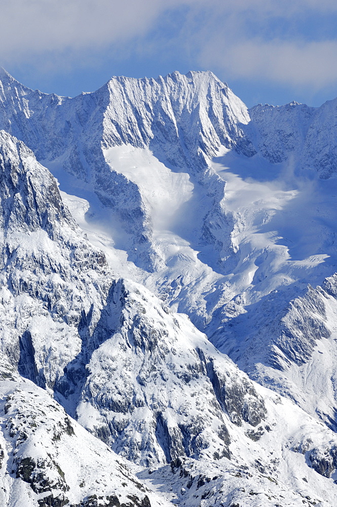 Clouds with freshly snow covered mountains in the Aletsch area, Goms, Valais, Switzerland