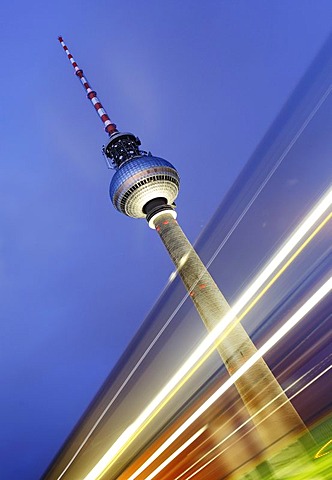 Time exposure of the Television Tower or Fernsehturm behind light streaks left by a passing car, Alexanderplatz, Berlin, Germany