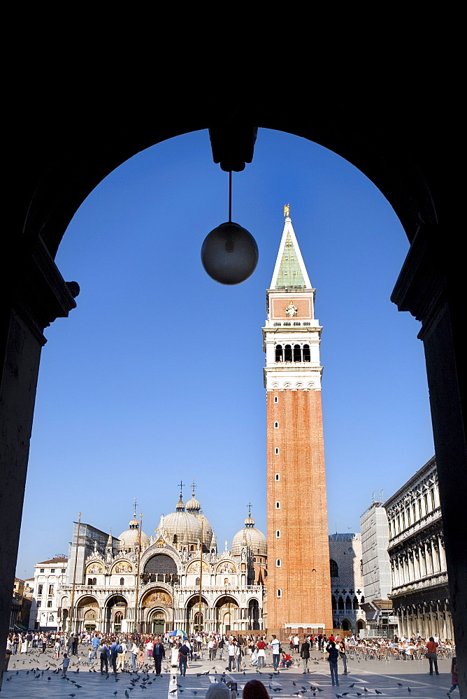 View through an arcade towards Basilica di San Marco, St. Mark's Basilica and Campanile, Venezia, Venice, Italy, Europe