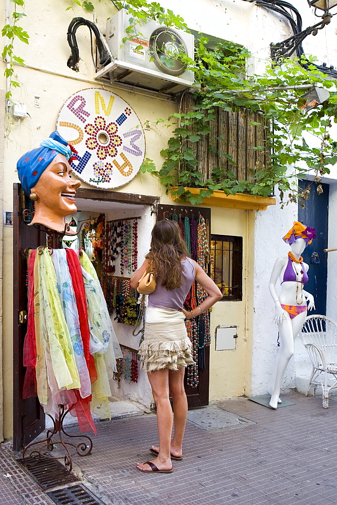 Customer in front of a shop in the historic centre of Dalt Villa, Ibiza, Balearic Islands, Spain, Europe