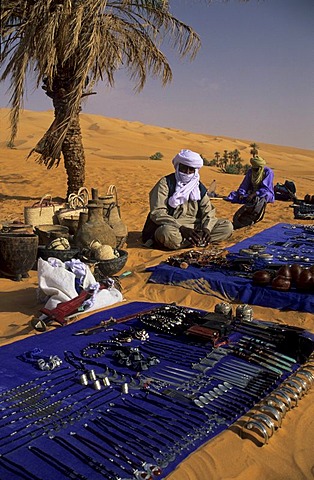 Touareg sitting in the sand selling souvenirs, Libya