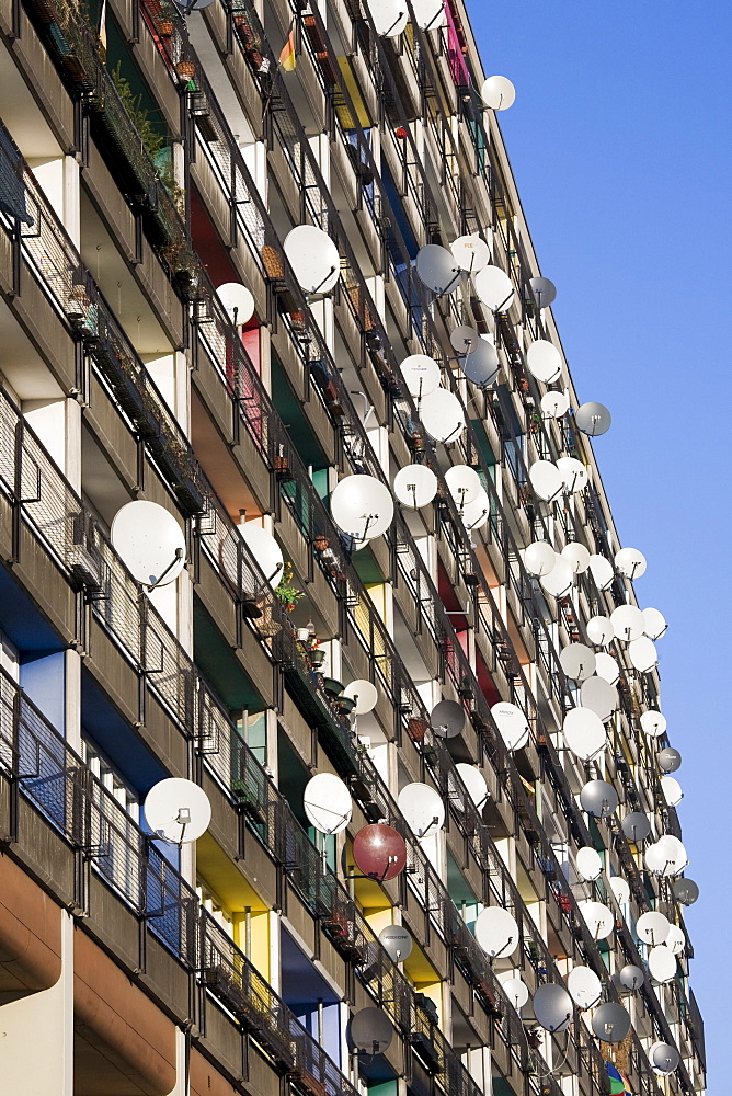 Lots of satellite dishes mounted to balconies on an apartment building facade, Pallasseum or "Berlin Social Palace" (Berliner Sozialpalast) apartment block in Schoenberg, Berlin, Germany, Europe