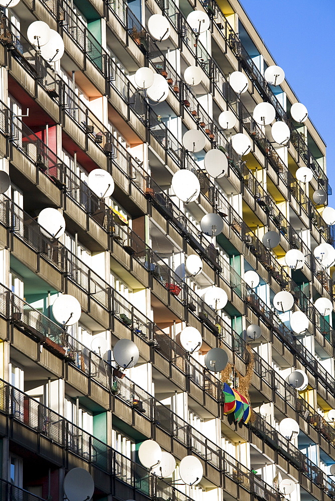 Lots of satellite dishes mounted to balconies on an apartment building facade, Pallasseum or "Berlin Social Palace" (Berliner Sozialpalast) apartment block in Schoenberg, Berlin, Germany, Europe